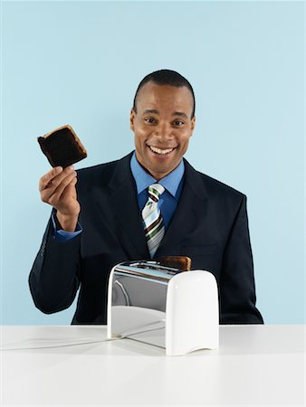Businessman with Burnt Toast Stock Photo - Rights-Managed, Code: 700-00659594