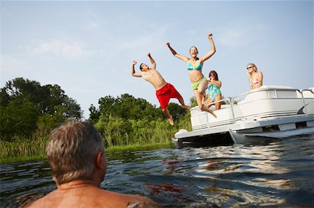 simsearch:614-06402622,k - Teens Jumping off Boat Stock Photo - Rights-Managed, Code: 700-00651348