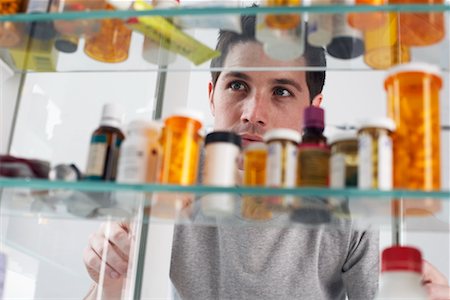 Man Looking in Medicine Cabinet Stock Photo - Rights-Managed, Code: 700-00661016