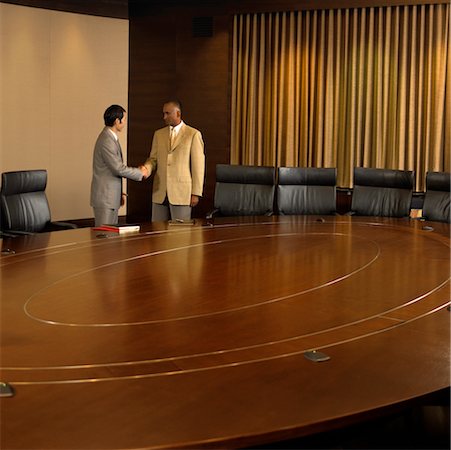 Businessmen Shaking Hands In Conference Room Stock Photo - Rights-Managed, Code: 700-00661396