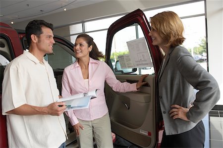 sales associate talking with customer - Car Saleswoman Talking to Clients Stock Photo - Rights-Managed, Code: 700-00688474