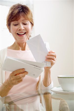 person holding stacks of paper - Woman Looking At Bills Stock Photo - Rights-Managed, Code: 700-00688664