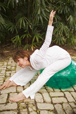 simsearch:633-06322404,k - Woman Doing Stretches On Exercise Ball Outdoors Stock Photo - Rights-Managed, Code: 700-00688662