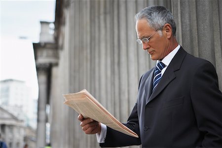 Businessman Reading Newspaper Stock Photo - Rights-Managed, Code: 700-00680942