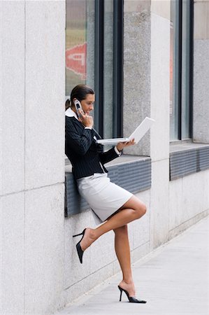 sidewalk heels - Businesswoman Using Laptop and Cellular Phone Stock Photo - Rights-Managed, Code: 700-00681433