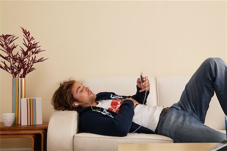 simsearch:700-00683268,k - Man Listening to MP3 Player on Sofa Stock Photo - Rights-Managed, Code: 700-00683265