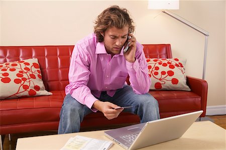 Man Doing Online Banking and Using Cell Phone Stock Photo - Rights-Managed, Code: 700-00683267