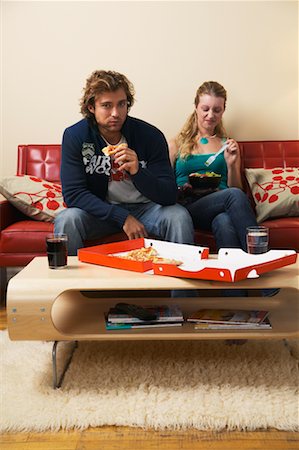 dinner on the couch - Man Eating Pizza and Woman Eating Salad Stock Photo - Rights-Managed, Code: 700-00683312
