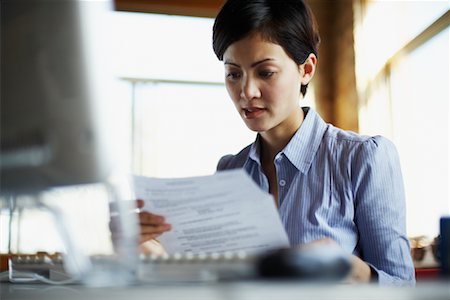 Woman Reading Printout Stock Photo - Rights-Managed, Code: 700-00695829