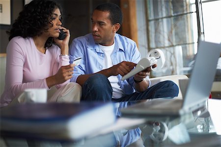 Couple Looking at Printout Together Stock Photo - Rights-Managed, Code: 700-00695845