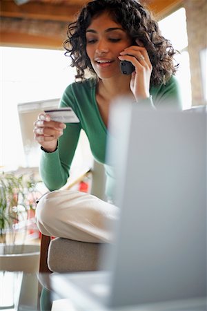 Woman Using Credit Card over Telephone Stock Photo - Rights-Managed, Code: 700-00695841