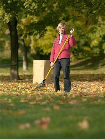 raking leaves - Woman Raking Leaves Stock Photo - Rights-Managed, Code: 700-00695874