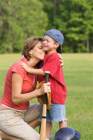 single mom at sons baseball game - Mother Comforting Son Stock Photo - Rights-Managed, Code: 700-00711627