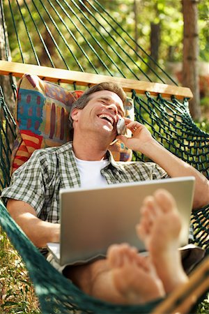 Man Lying on Hammock and Talking on Cellular Phone Stock Photo - Rights-Managed, Code: 700-00747975