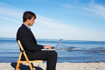 Businessman Using Laptop at Beach Stock Photo - Rights-Managed, Code: 700-00748153