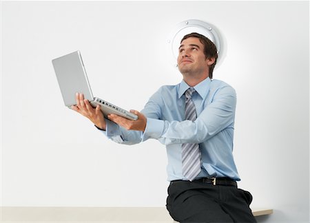 question funny - Portrait of Businessman Holding Laptop Computer Stock Photo - Rights-Managed, Code: 700-00748558