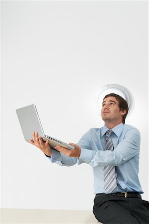 Portrait of Businessman Holding Laptop Computer Stock Photo - Rights-Managed, Code: 700-00748559