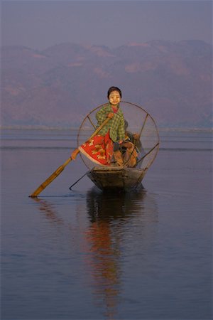 Girl Rowing Boat With Leg, Inle Lake, Shan State, Myanmar Stock Photo - Rights-Managed, Code: 700-00768072