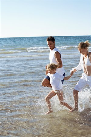 father daughter water splashing - Parents Running through Water with Daughter Stock Photo - Rights-Managed, Code: 700-00768237