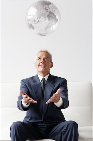 Businessman Throwing Globe Stock Photo - Rights-Managed, Code: 700-00782343