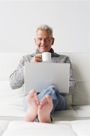 Man Drinking Coffee and Working on Laptop Stock Photo - Rights-Managed, Code: 700-00782354