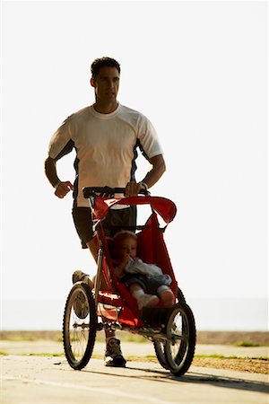 running, stroller - Man Jogging along Beach with Stroller Stock Photo - Rights-Managed, Code: 700-00782593