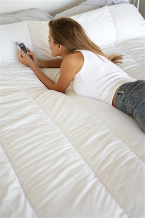 simsearch:700-00782647,k - Woman Lying on Bed, Using Cell Phone Stock Photo - Rights-Managed, Code: 700-00782646