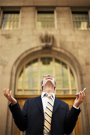 Businessman Looking Up with Cellular Phone Stock Photo - Rights-Managed, Code: 700-00795870