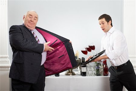 funny wine in the workplace - Man Showing Inside of Suit Jacket As Waiter is About to Spill Wine Stock Photo - Rights-Managed, Code: 700-00796275