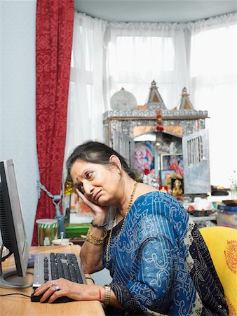 sad indian woman images - Woman Sitting at Computer Stock Photo - Rights-Managed, Code: 700-00796661