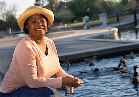 squatting feeding birds - Woman Feeding Ducks In The Park Stock Photo - Rights-Managed, Code: 700-00846794