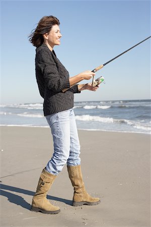 pescatrice - Woman Fishing on Beach Fotografie stock - Rights-Managed, Codice: 700-00846960