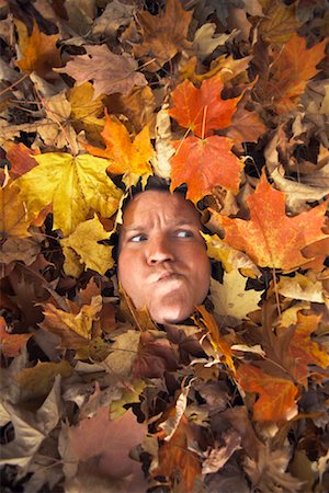 Man Buried Under Leaves Stock Photo - Rights-Managed, Code: 700-00847668