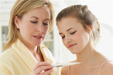 Mother and Daughter Looking at Thermometer Stock Photo - Rights-Managed, Code: 700-00864963