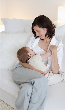 Woman Breastfeeding Baby on Sofa Stock Photo - Rights-Managed, Code: 700-00865696
