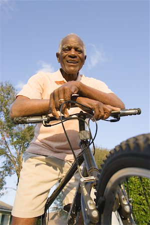 Black old man riding a bicycle Stock Photos Page 1 Masterfile