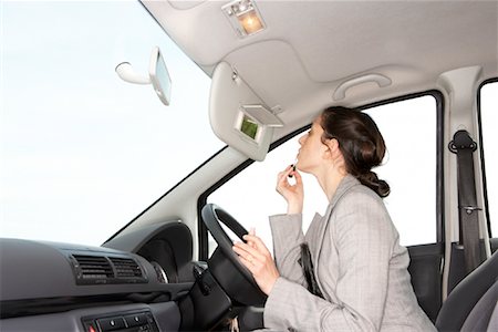 putting on lipstick - Businesswoman Applying Make-Up Stock Photo - Rights-Managed, Code: 700-00916989