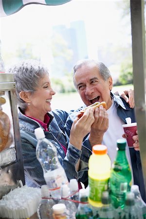 playful couple eating together - Couple at Hot Dog Stand Stock Photo - Rights-Managed, Code: 700-00917681
