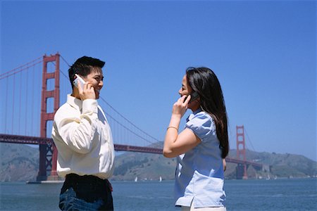 famous people in california - Couple on Cell Phones Outdoors, San Fransisco, California, USA Stock Photo - Rights-Managed, Code: 700-00918036