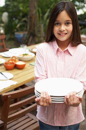 Girl Setting Table For Dinner Outdoors Stock Photo - Rights-Managed, Code: 700-00918117