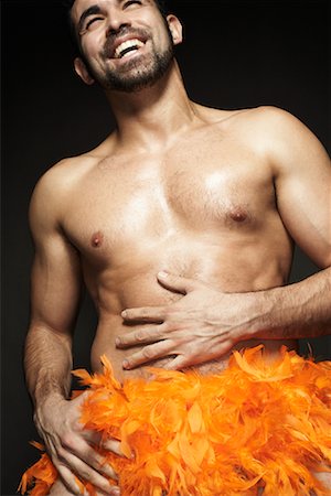 Man with Feather Boa around Waist Stock Photo - Rights-Managed, Code: 700-00910251