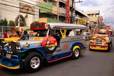 filipino (lugares y cosas) - Jeepneys on Road, Dagupan City, North Luzon, Philippines Foto de stock - Con derechos protegidos, Código: 700-00910863
