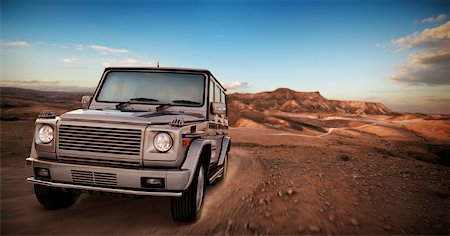 simsearch:700-01164946,k - SUV Driving on Dirt Road Through Desert Stock Photo - Rights-Managed, Code: 700-00912275