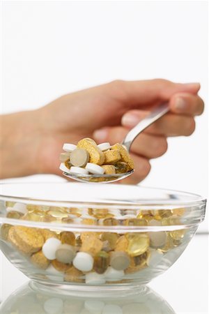 eat with cereal bowl with spoon - Woman's Hand Holding Spoonful of Pills Stock Photo - Rights-Managed, Code: 700-00934505