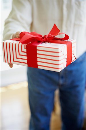 picture of man with red bow - Man Holding Present Stock Photo - Rights-Managed, Code: 700-00934904