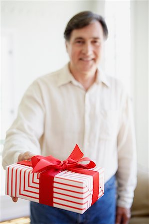picture of man with red bow - Man Holding Gift Stock Photo - Rights-Managed, Code: 700-00934905