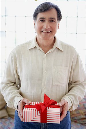 picture of man with red bow - Man Holding Present Stock Photo - Rights-Managed, Code: 700-00934903