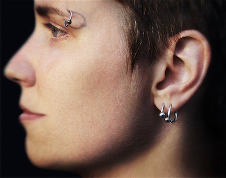 simsearch:400-04363188,k - Profile of Woman with Eyebrow and Ear Piercings Stock Photo - Rights-Managed, Code: 700-00933633