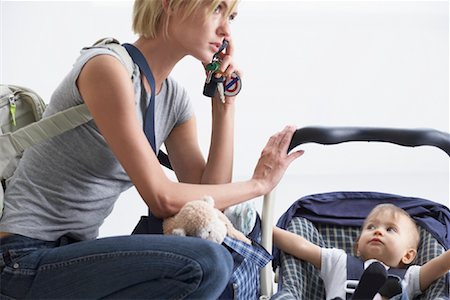 frustrated child white background - Mother With Baby in Baby Carrier Stock Photo - Rights-Managed, Code: 700-00933654