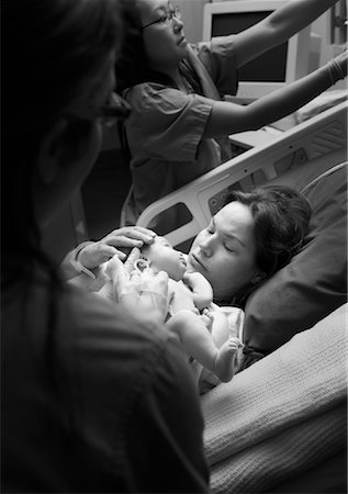 picture of a patient in a hospital bed with family and nurse - Mother Holding Newborn Baby Stock Photo - Rights-Managed, Code: 700-00948181
